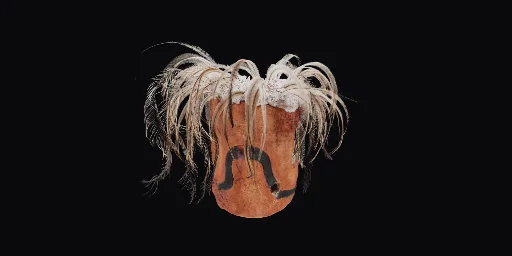 A brown textured ceramic object with emu feathers placed around opening of the top of the object.